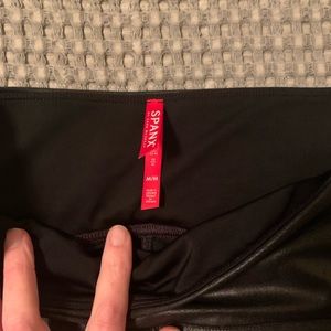 Spanks Faux leather leggings.